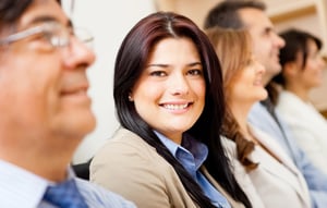 Business woman smiling in a corporate meeting