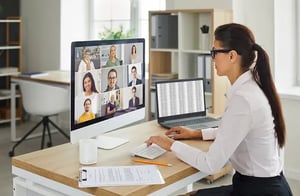 woman professional working on a computer attending a Zoom meeting