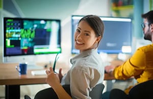 female software developer turning around smiling at the camera