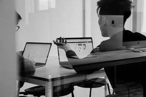 customer service reps sitting in front of their computers at their office